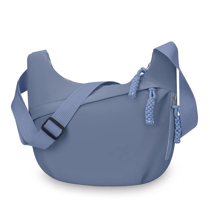 Blue shoulder bag with a strap on a white background