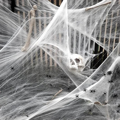 Halloween decoration with spider webs, a skull, and spiders on a staircase.
