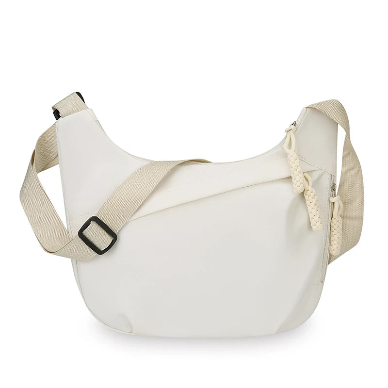 White shoulder bag with beige strap on a white background