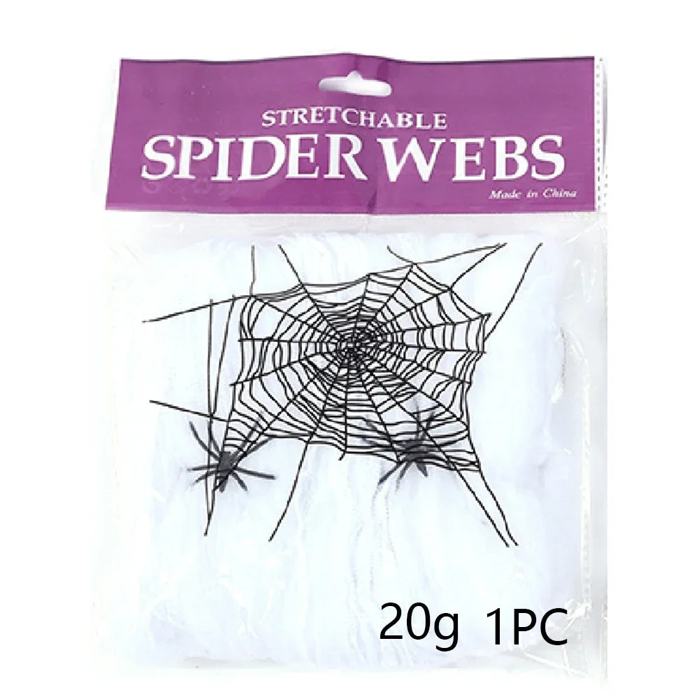 Packaged stretchable spider webs Halloween decoration, containing a large black elastic web and two small spider figures inside a clear plastic bag with a purple header card.