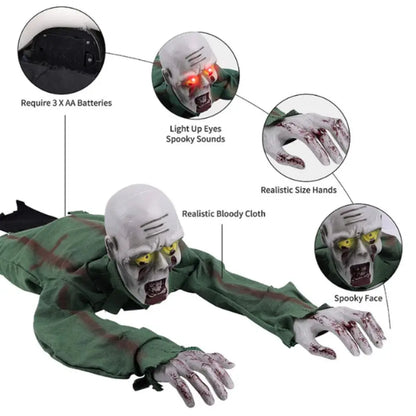 A Halloween zombie prop shown on a white background with callout circles and text explaining features: 3 AA batteries, light-up eyes with spooky sounds, realistic size hands, and a spooky face. The figure is wearing a green blood-splattered costume and has pale gray skin.