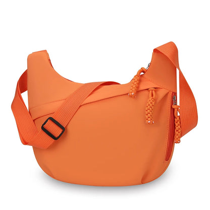Orange shoulder bag with a strap on a white background
