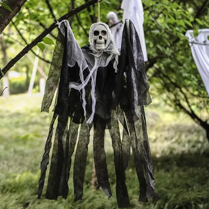 Hanging skeleton decoration with draped fabric in a natural setting