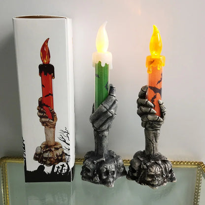 Decorative candle holders with candles in front of a box featuring similar design.