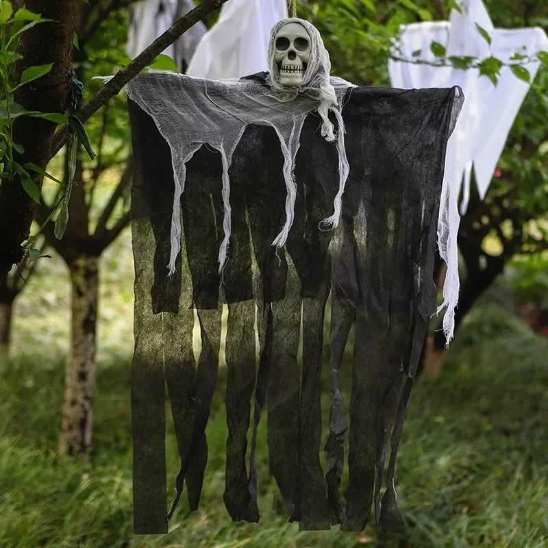 Hanging ghost decoration with a skeleton head in a forest setting