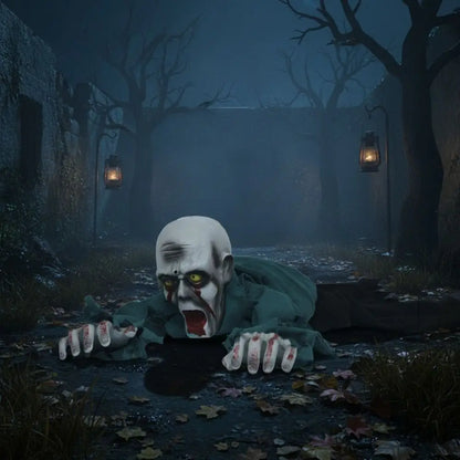 A creepy Halloween zombie prop crawling forward in a dark, foggy outdoor alley with bare trees and hanging lanterns.