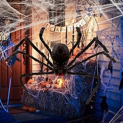 Halloween decoration with a large spider and cobwebs in a house setting.