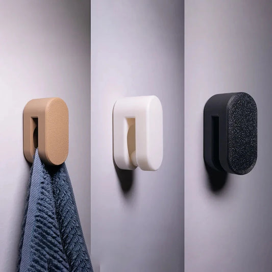 Automatic locking towel hook holding a towel securely on a wall-mounted holder.